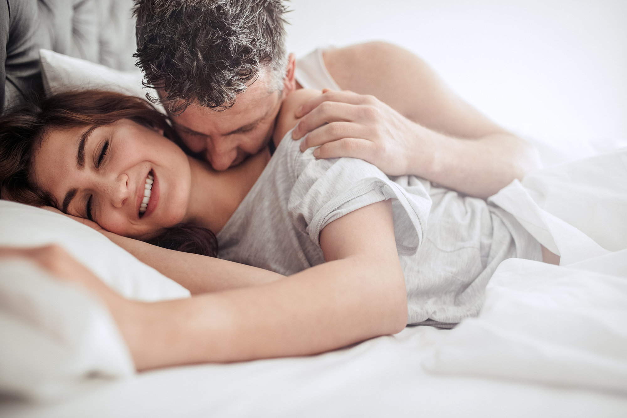 couple kissing bed