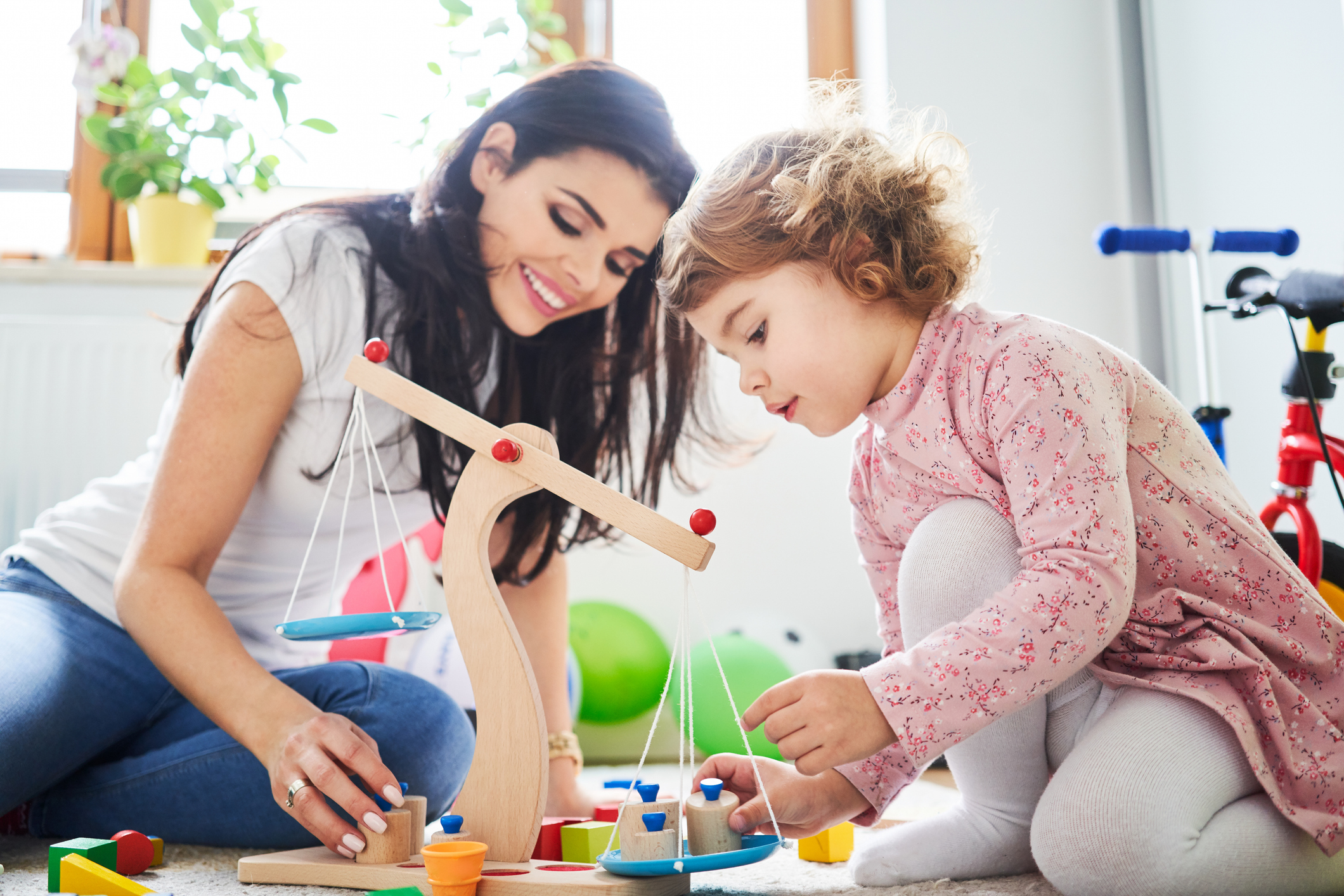 Mother spending time with her daughter playing with toys Mother spending time with her daughter playing with toys