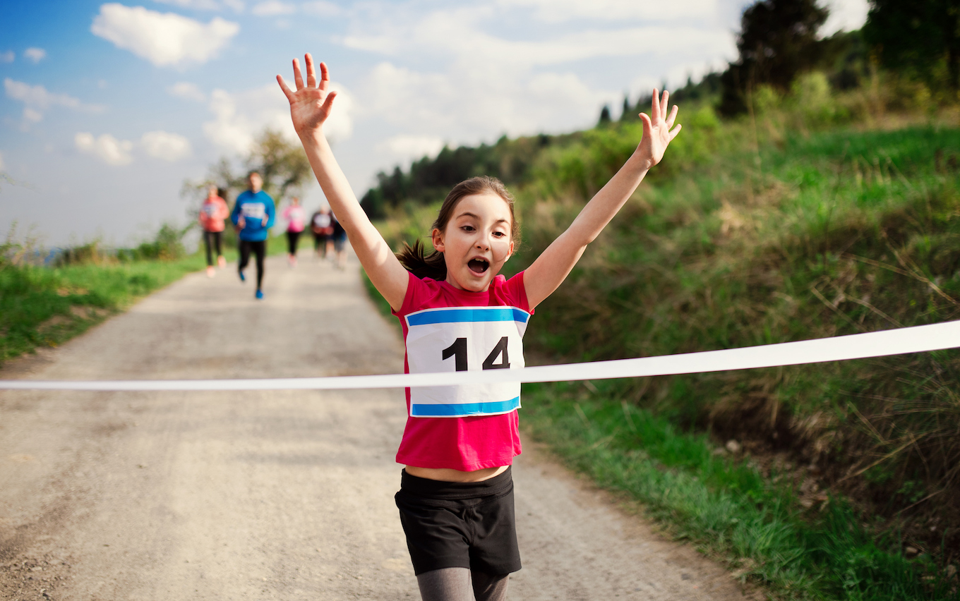 girl runner crossing finish line girl runner crossing finish line