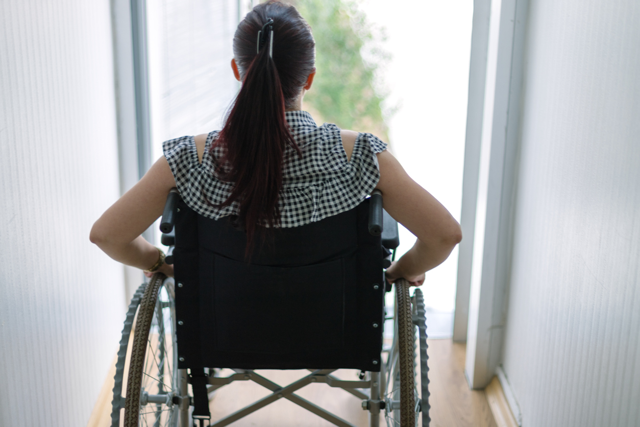 Thoughtful businesswoman in a wheelchair at work Thoughtful businesswoman in a wheelchair at work