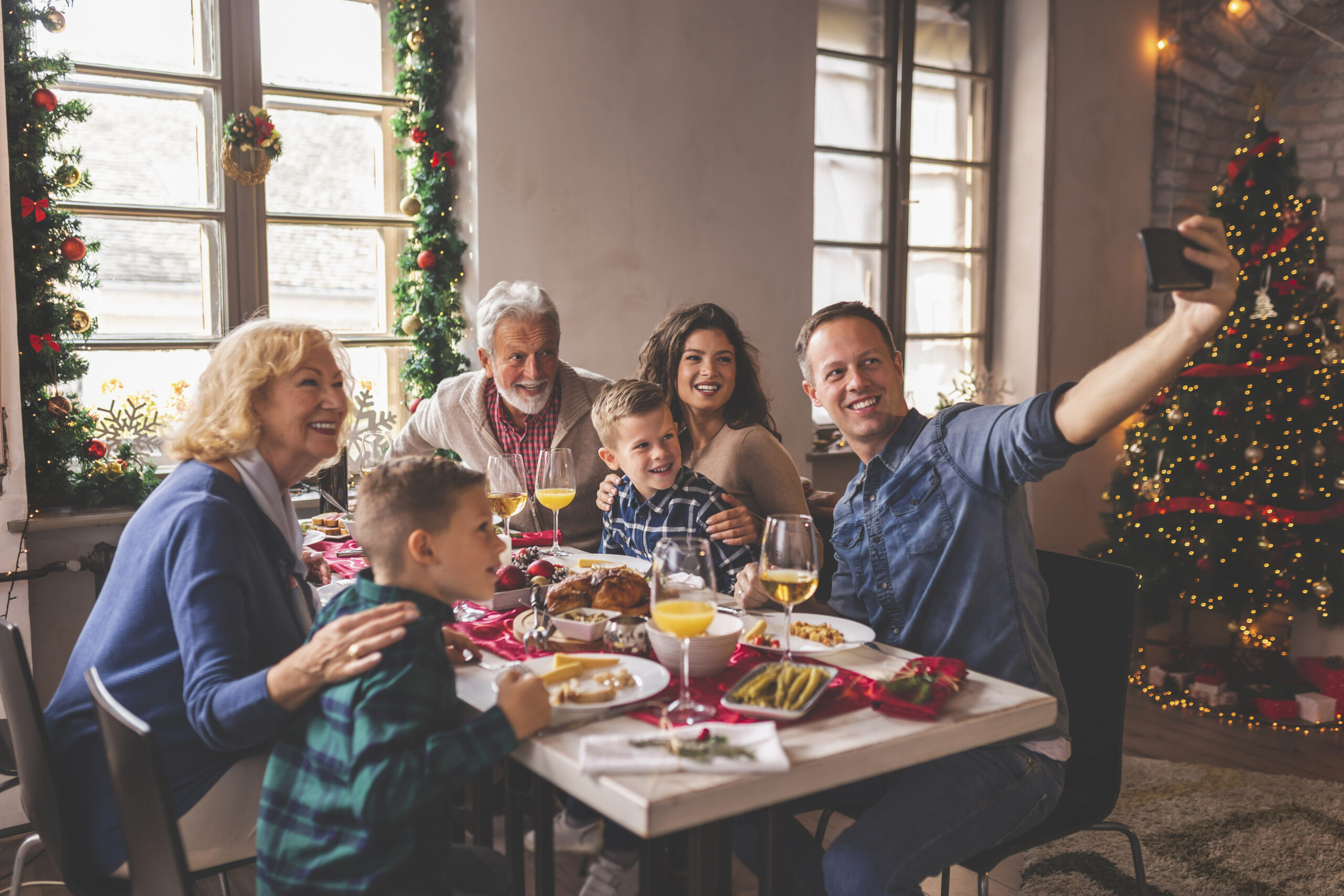 Family taking a selfie during Christmas dinner Family taking a selfie during Christmas dinner