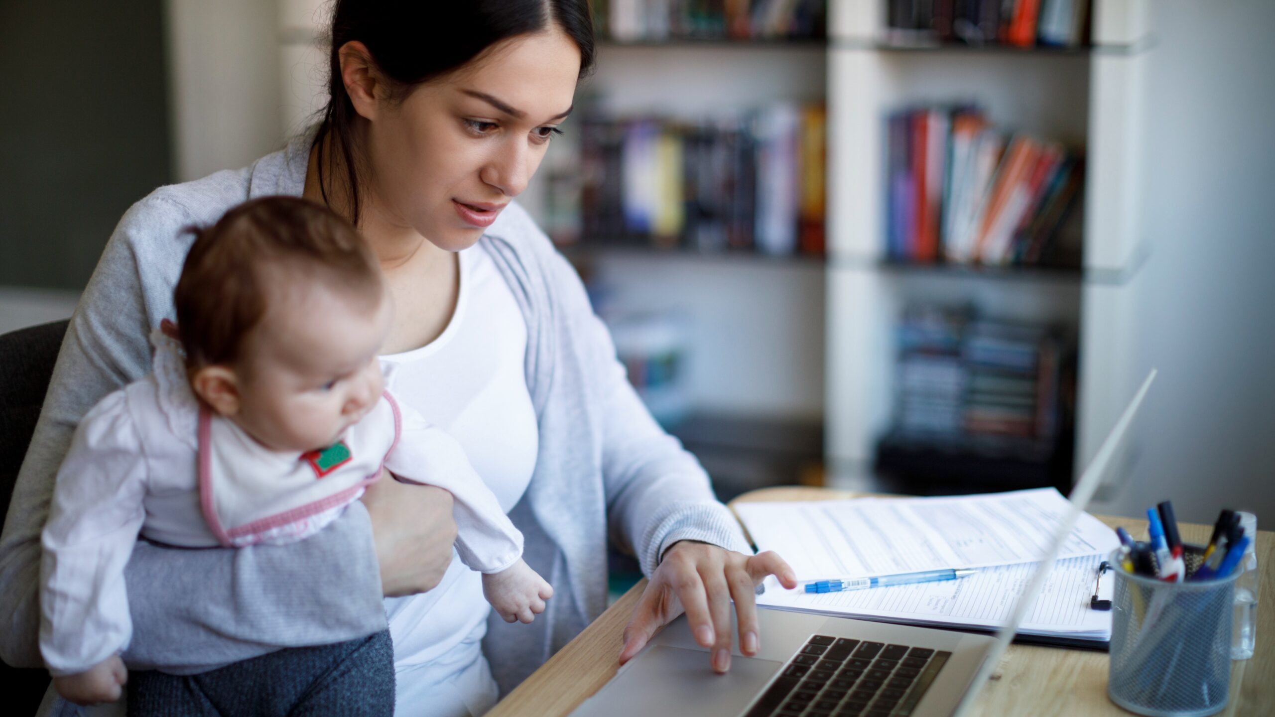 woman holding baby on the computer woman holding baby on the computer