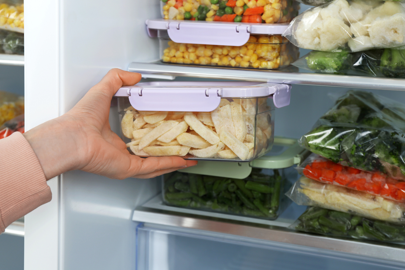 Woman putting food in freezer Woman putting food in freezer