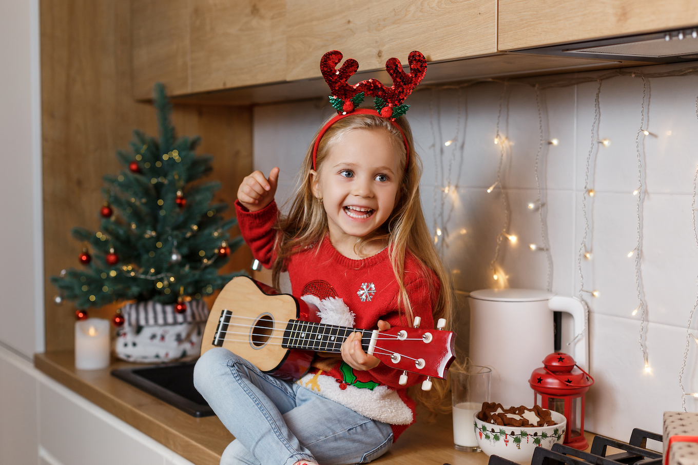 Girl playing the ukulele on Christmas Girl playing the ukulele on Christmas