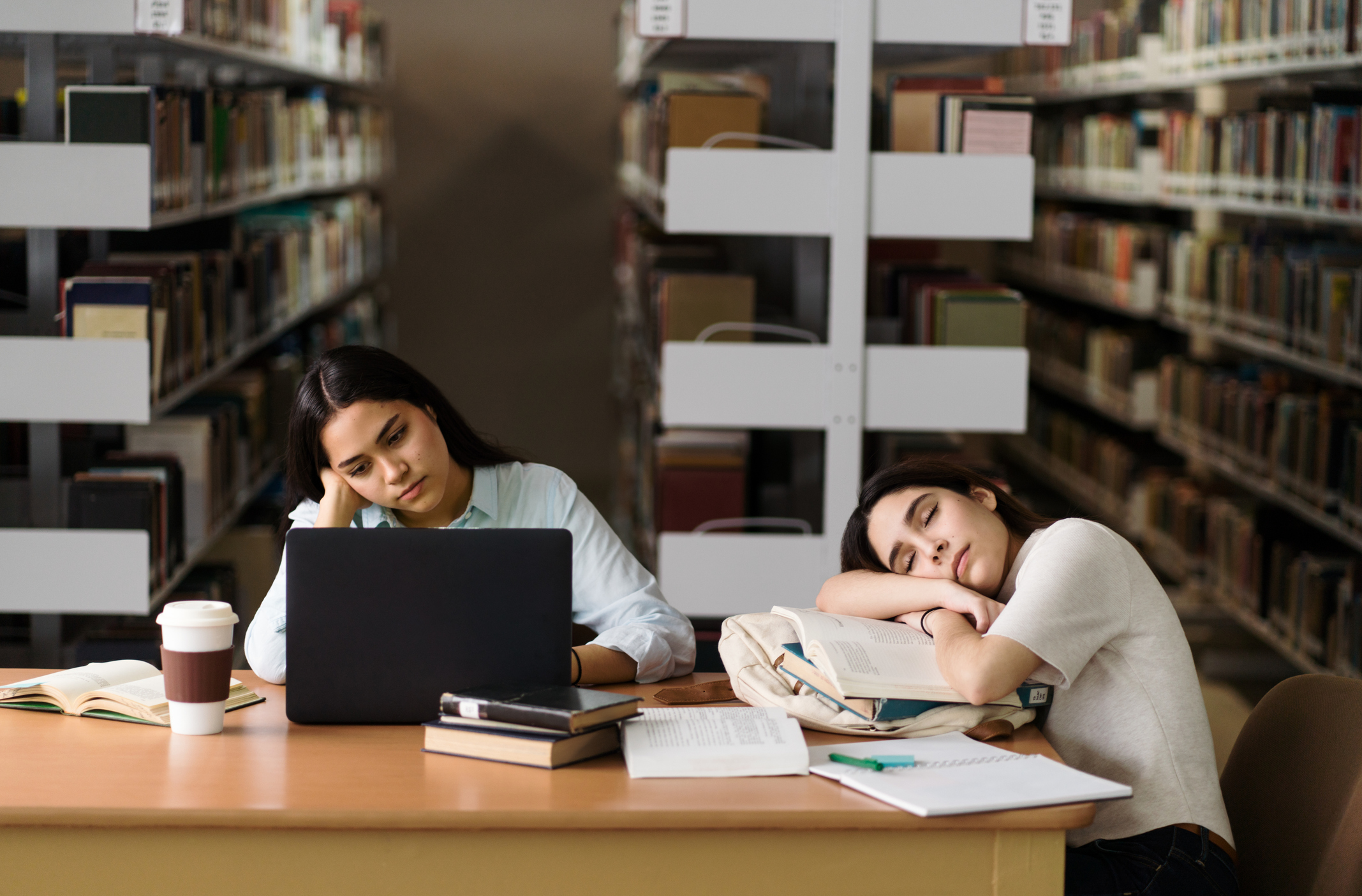 Female student being tired at library Female student being tired at library