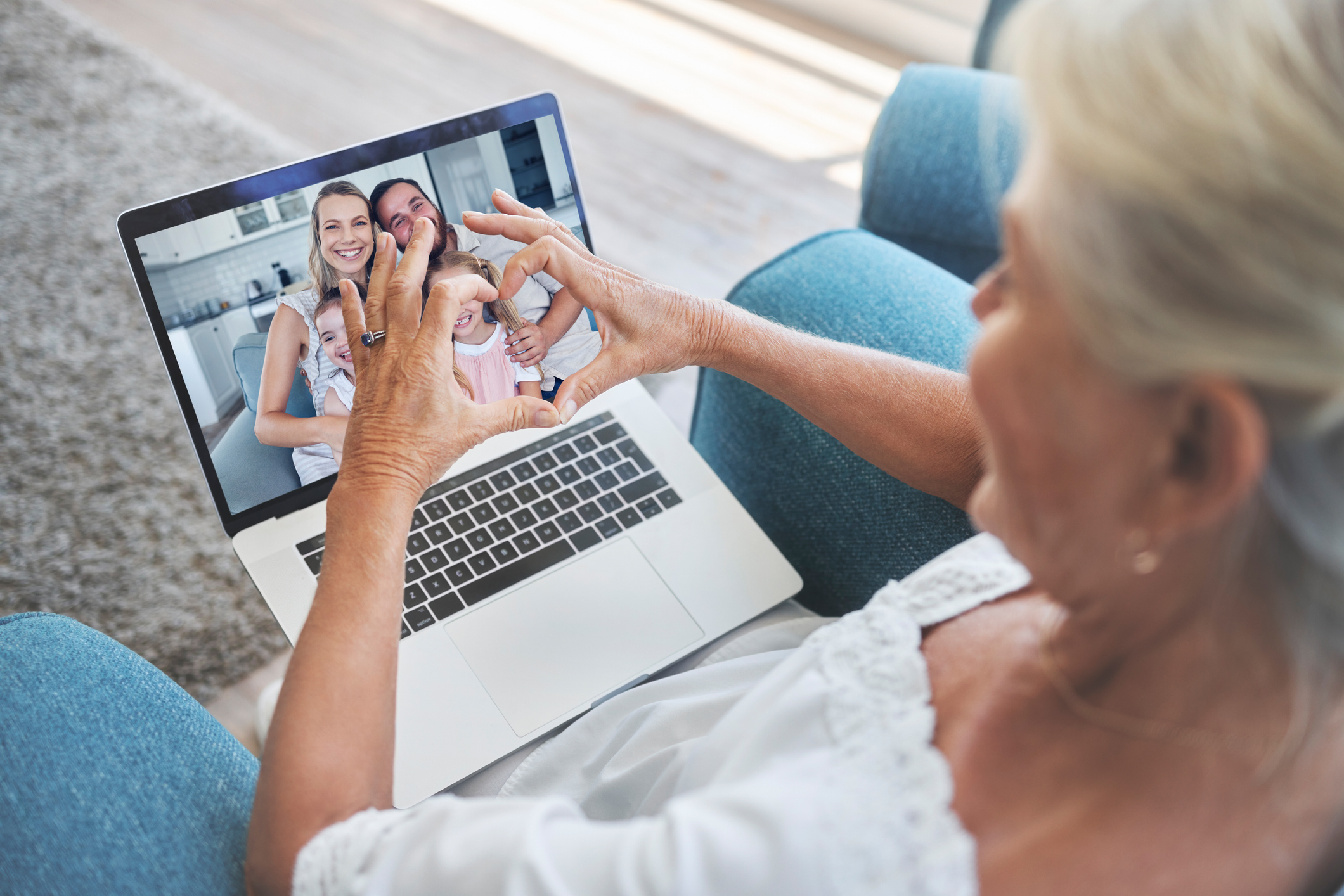 Happy family, heart and grandma on a video call via laptop internet connection loves talking to kid and grandchildren. Online, grandmother and parents with kids enjoying a virtual conversation in USA Happy family, heart and grandma on a video call via laptop internet connection loves talking to kid and grandchildren. Online, grandmother and parents with kids enjoying a virtual conversation in USA