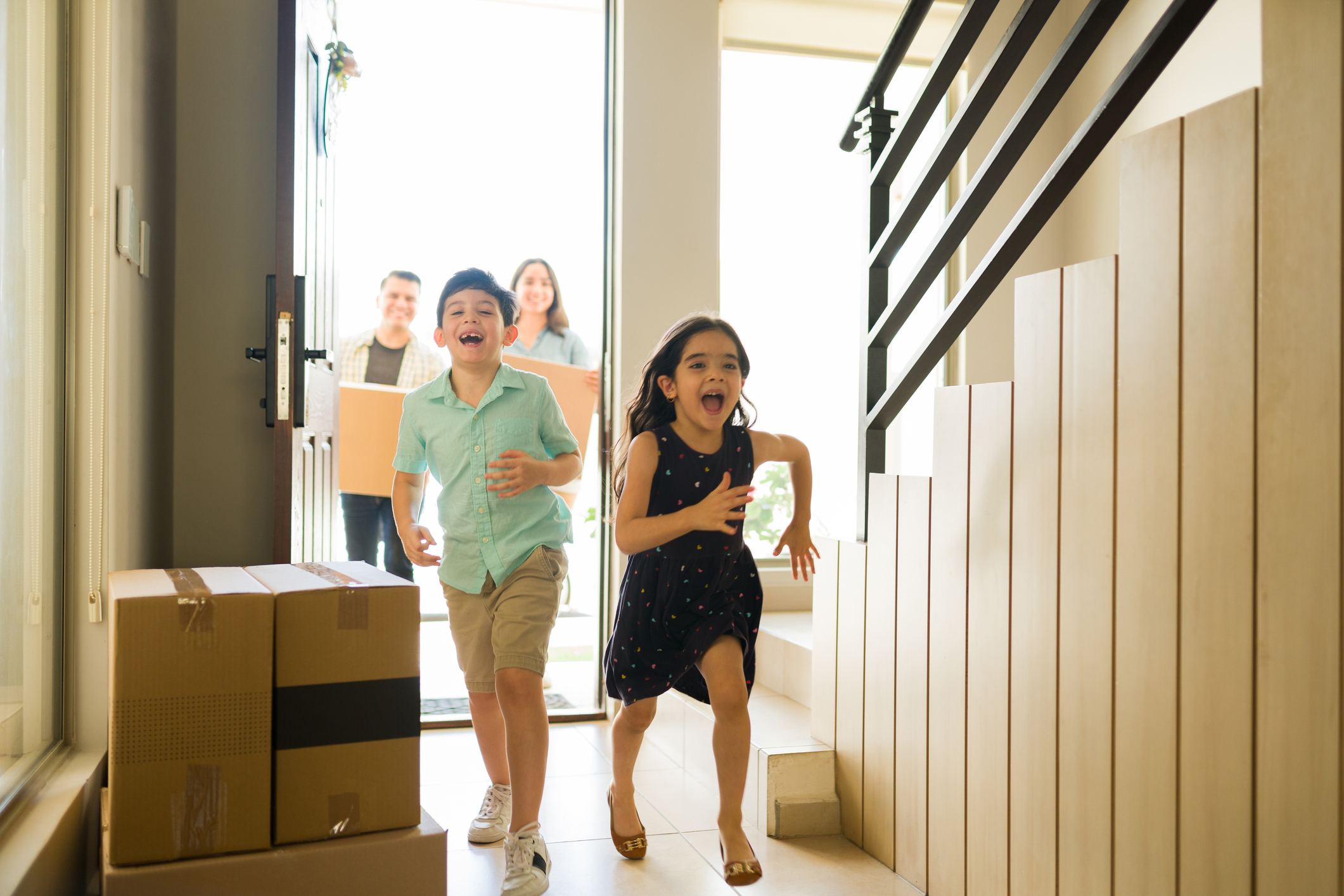 Excited kids moving in and laughing while running in their new home Excited kids moving in and laughing while running in their new home