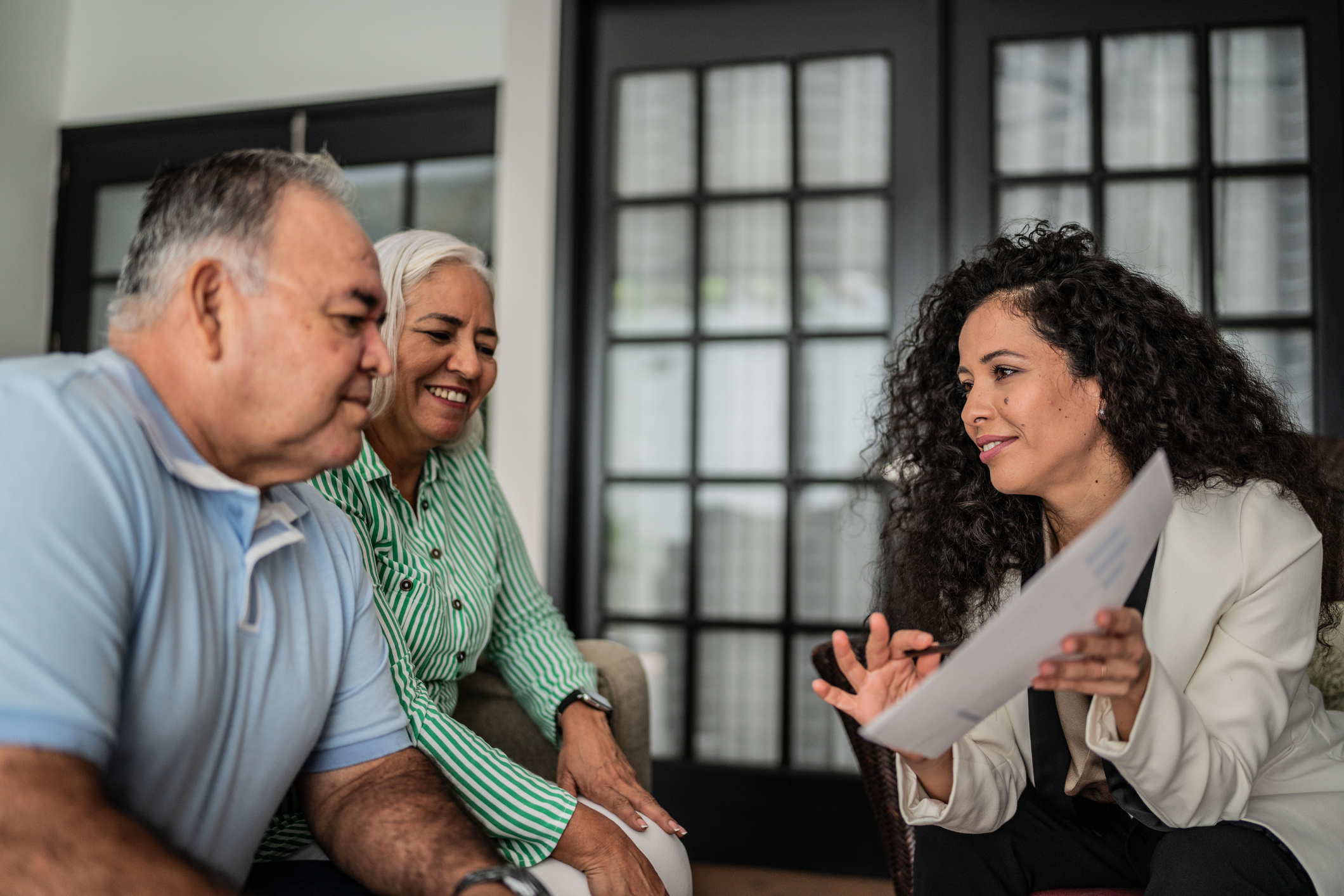 Financial advisor having a meeting with senior couple at home Financial advisor having a meeting with senior couple at home