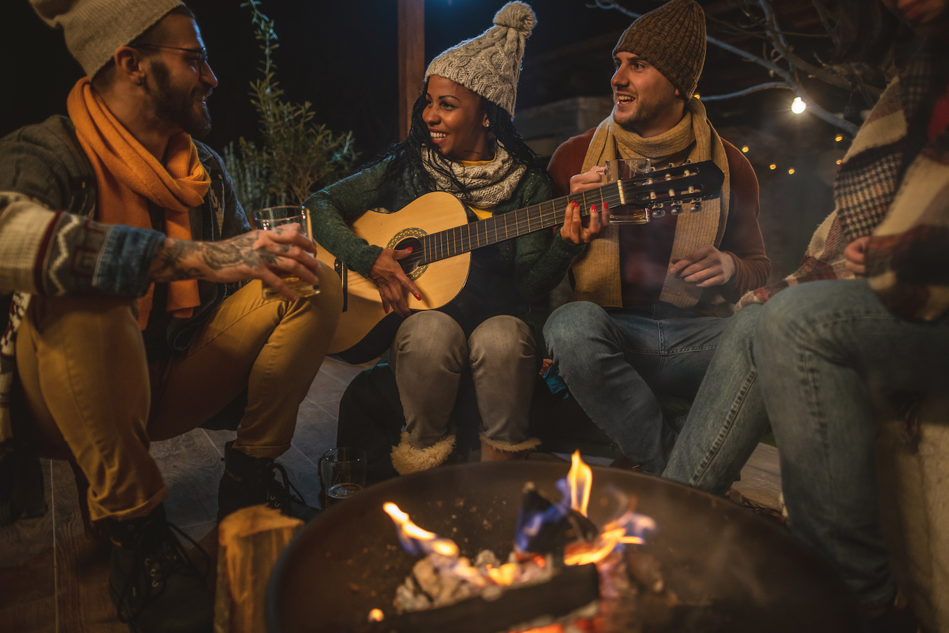 People playing music by a campfire People playing music by a campfire