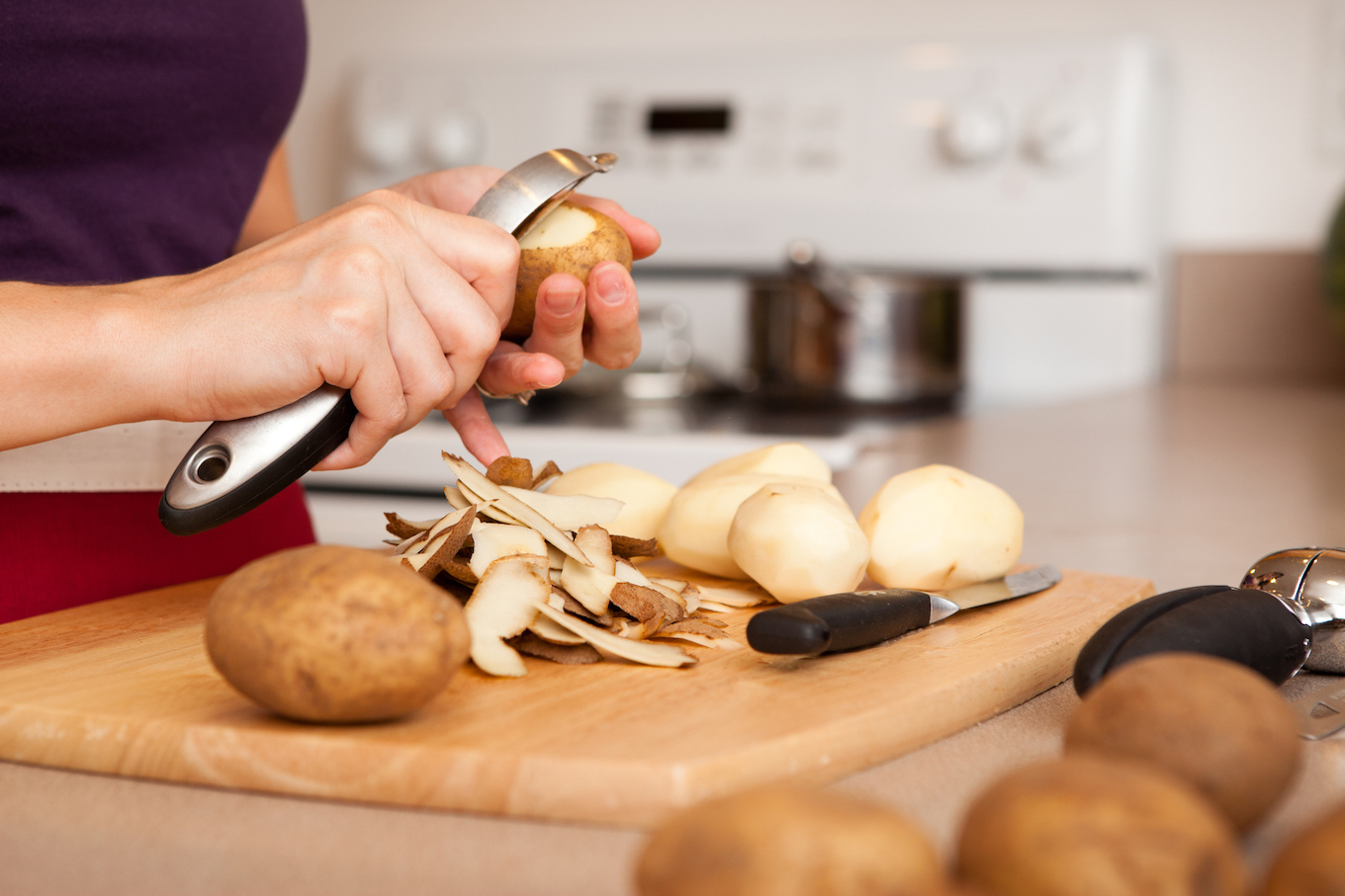 Woman peeling potatoes Woman peeling potatoes