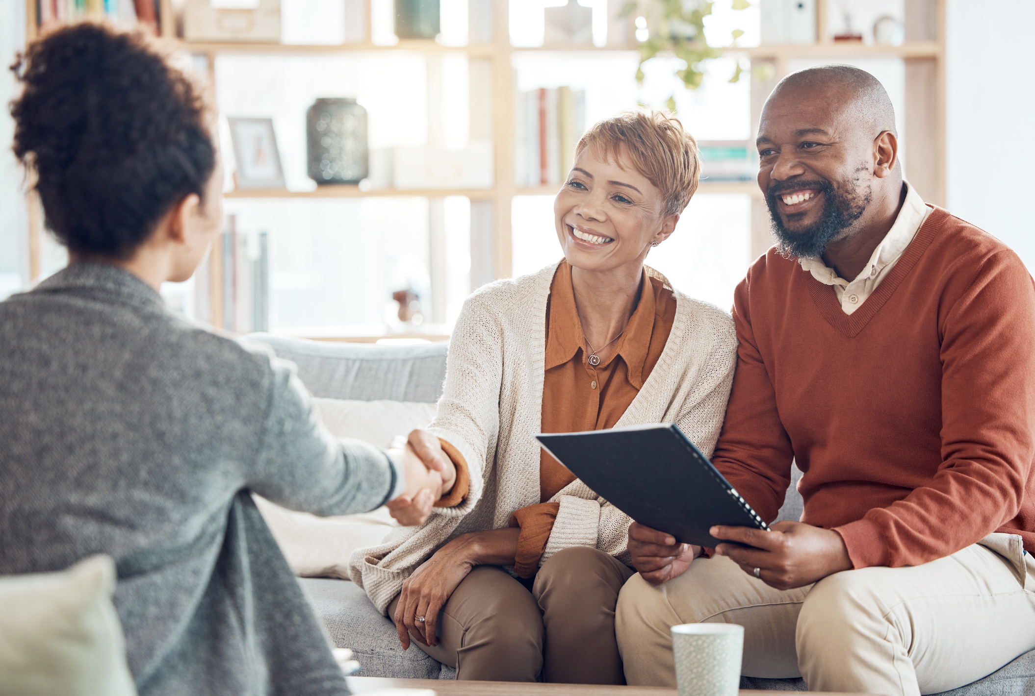 Business meeting, welcome handshake and couple meet with lawyer or financial advisor. Elderly married man, wife and woman retirement conversation, planning and insurance documents for estate finance Business meeting, welcome handshake and couple meet with lawyer or financial advisor. Elderly married man, wife and woman retirement conversation, planning and insurance documents for estate finance