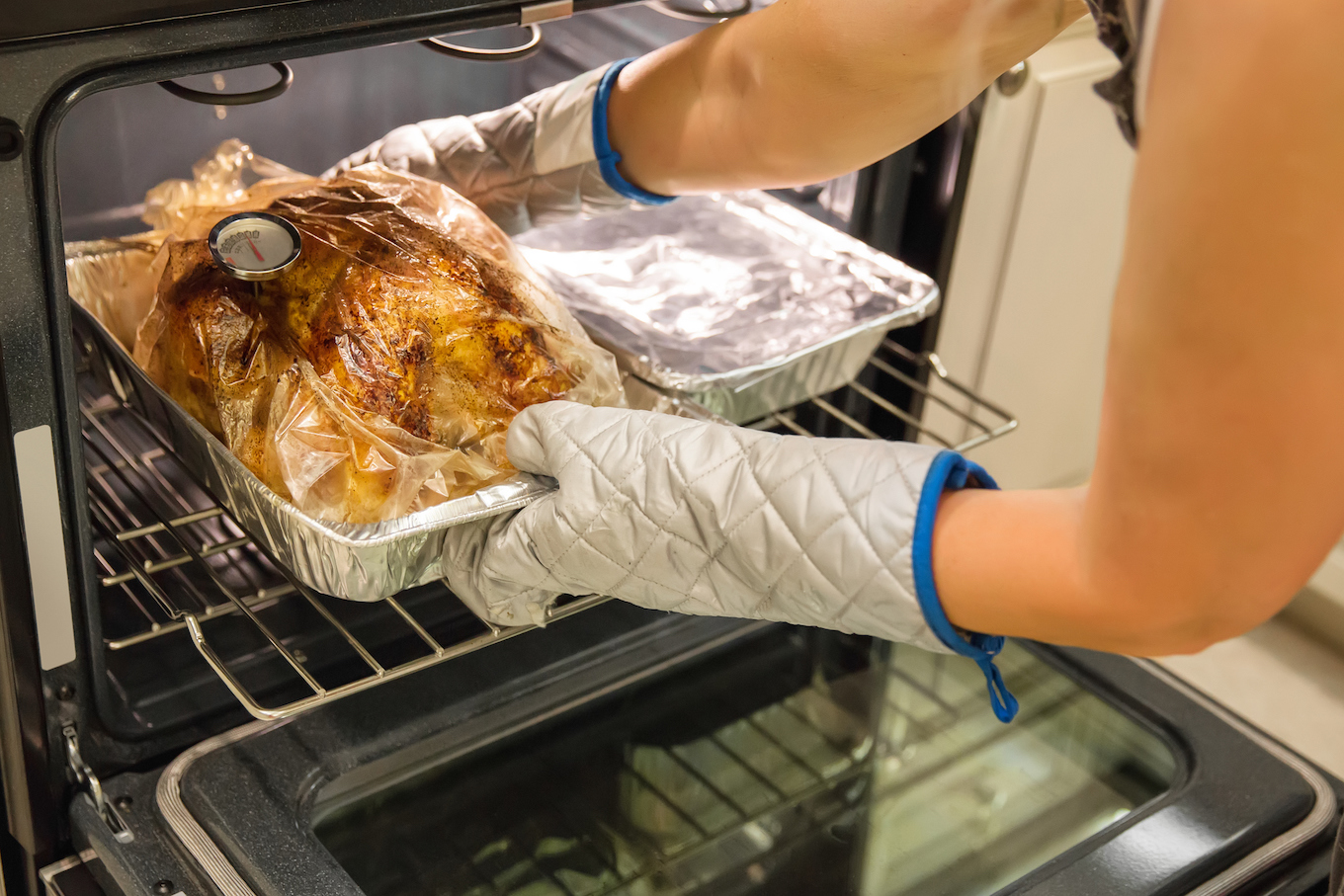 Putting turkey in the oven Putting turkey in the oven