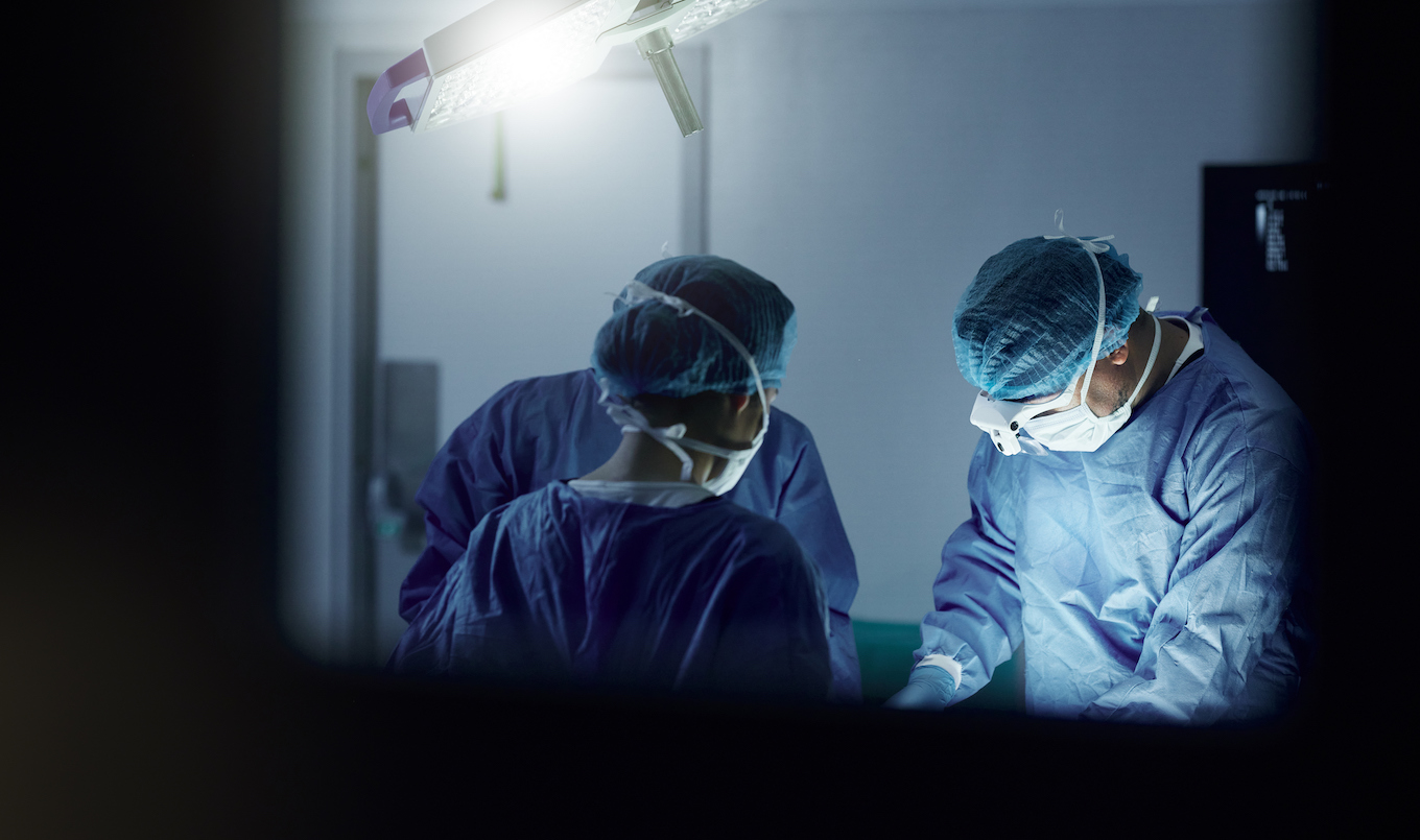 Teamwork, emergency and doctors in a hospital for surgery together, working in theater to save a life. Medical, healthcare and a surgeon team in the operating room of a clinic for an operation Doctors in operating room