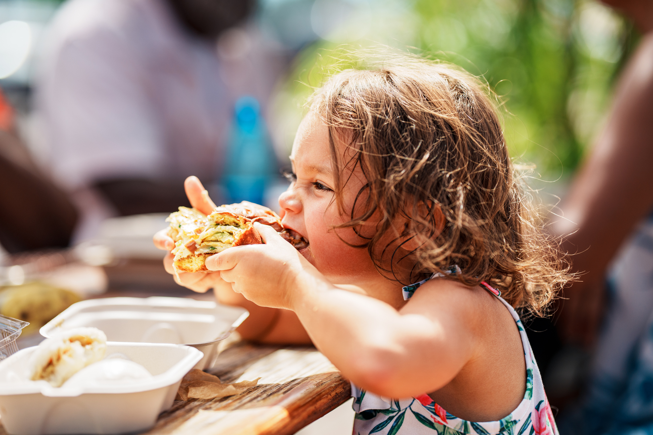 Eurasian girl eating street food while vacationing in Hawaii Eurasian girl eating street food while vacationing in Hawaii