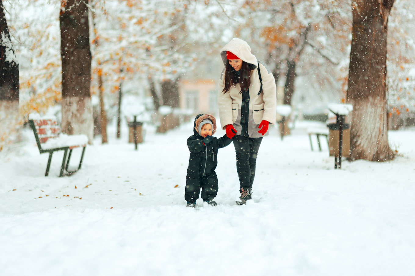 Mom and child walking in the snow Mom and child walking in the snow