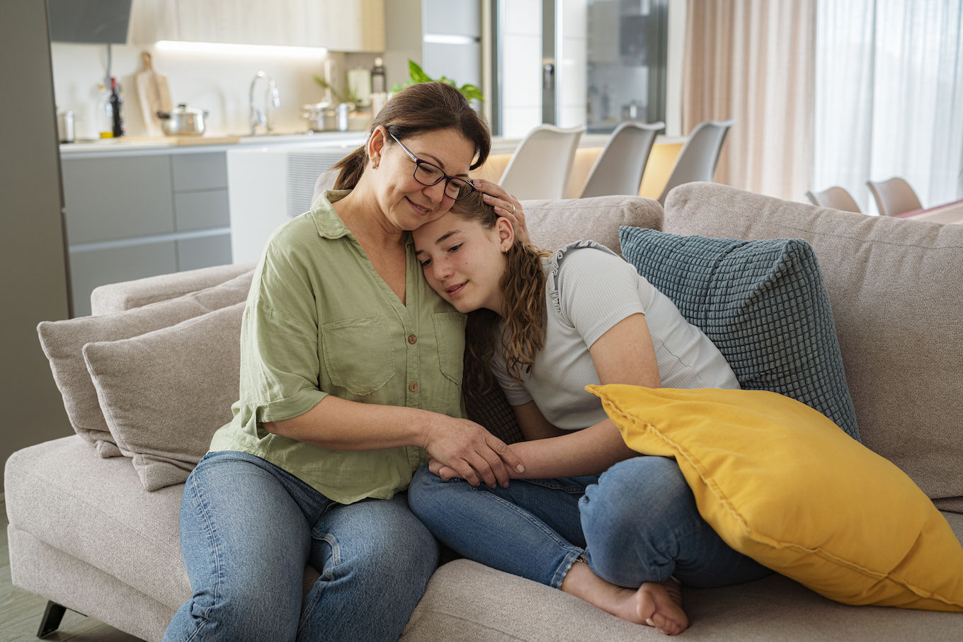 Mom hugging teen daughter Mom hugging teen daughter