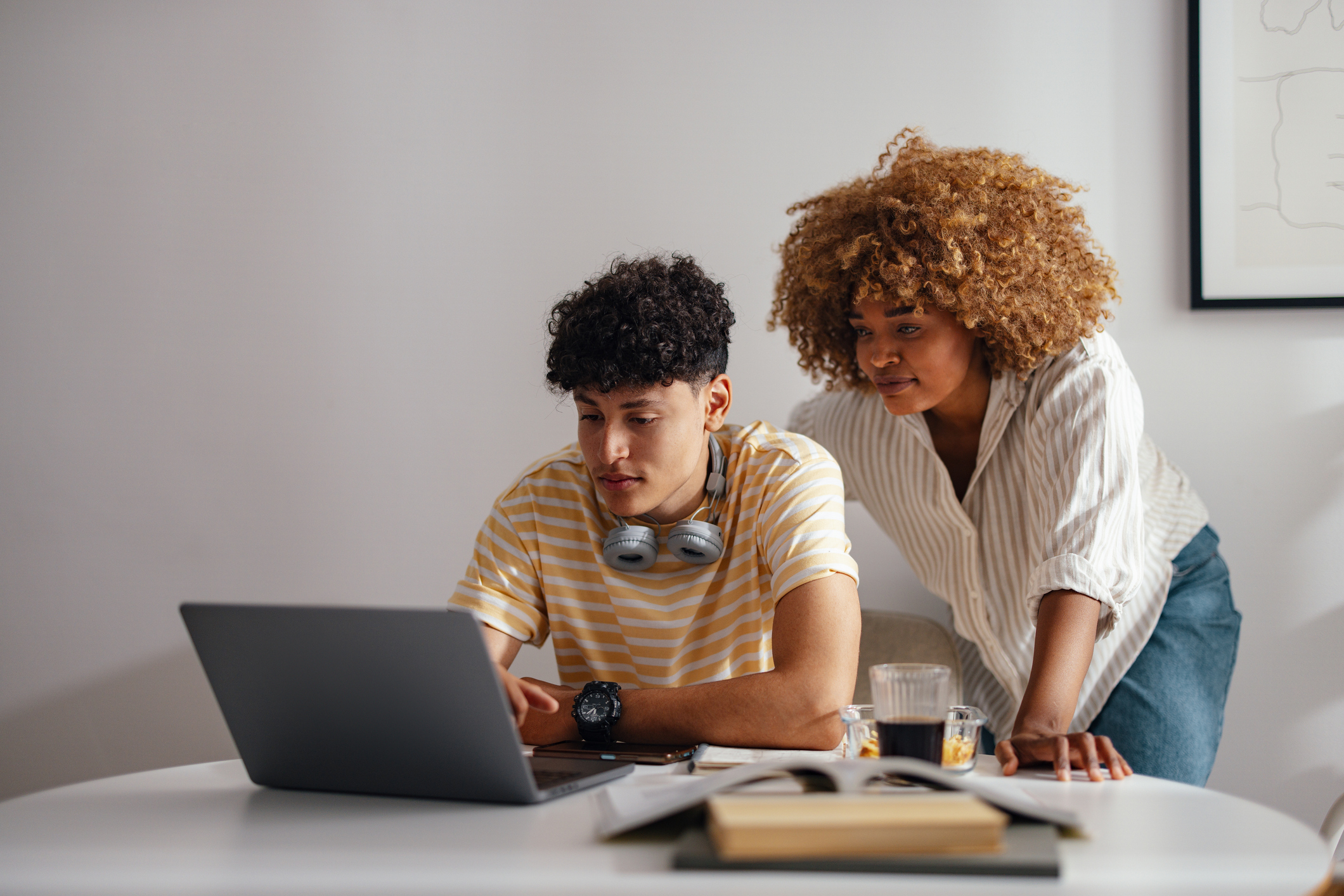 Mother and Teen Son Working Together on Laptop at Home Mother and Teen Son Working Together on Laptop at Home