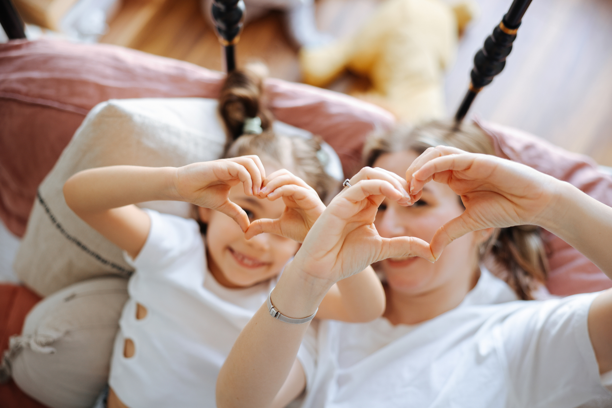 Young woman and her daughter meet in the morning in bed Young woman and her daughter meet in the morning in bed