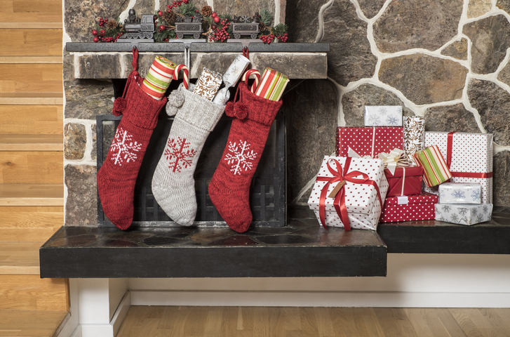 Christmas stockings and presents Stuffed stockings hanging on a fireplace on christmas morning
