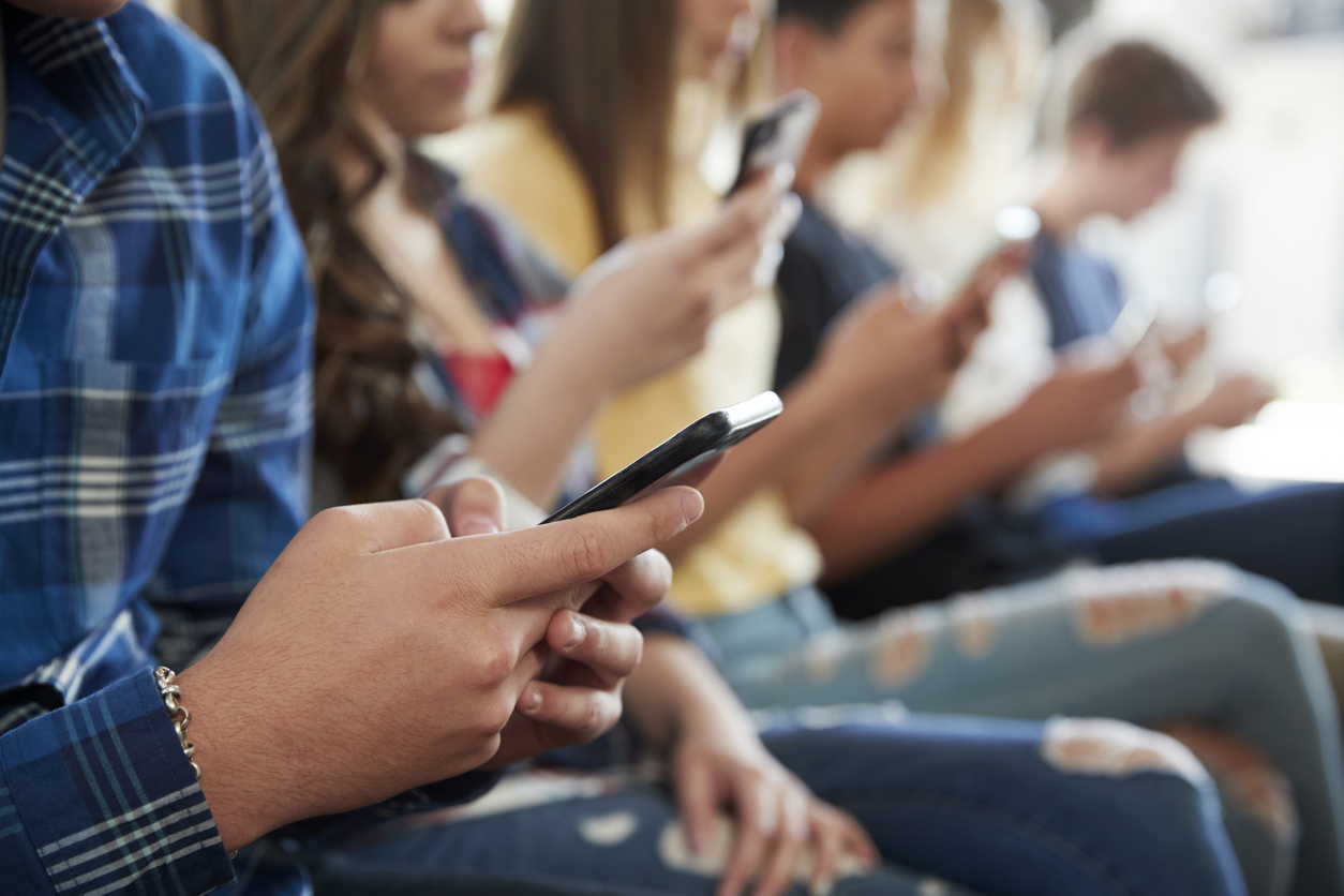 Students on their phones at school Students on their phones at school
